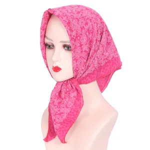 Detailed view of a pink rhinestone floral headscarf, lightweight square hijab for women.