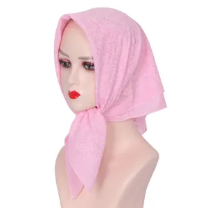 Detailed view of women pink square hijab with sparkling rhinestones, lightweight sheer headscarf.