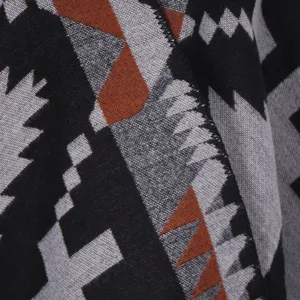 Cozy geometric patterned winter warm shawl cape detail view, soft imitation cashmere fabric.