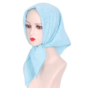 Light blue square hijab scarf with subtle floral patterns and rhinestones for daily wear detail view.