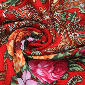 Close-up detail showing the vibrant red paisley printed fabric texture with intricate floral patterns.