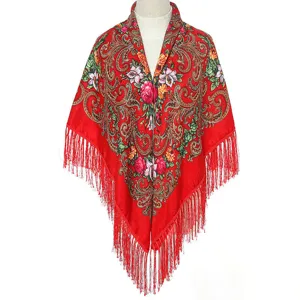 Detailed view of red ethnic floral tassel scarf with traditional printed patterns and fringe trim.