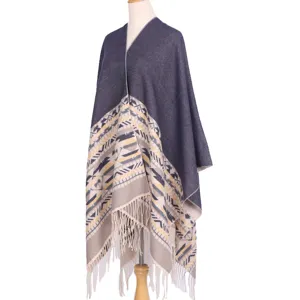 Detailed view of the thickened imitation cashmere tribal patterned poncho cape with fringe hem.