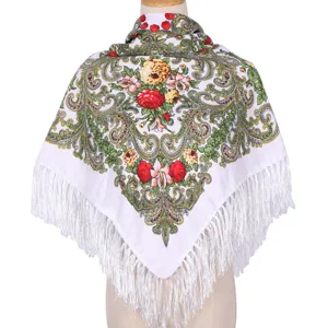 Detailed view of traditional ethnic floral print square scarf with delicate white fringe.