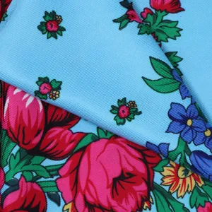 Russian style floral square scarf detail, vibrant pink and blue printed fabric texture close up
