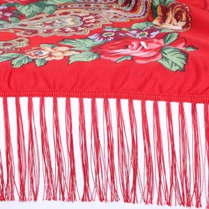 Close-up detail of red floral printed bohemian tassel scarf, ethnic retro fringe shawl wrap.