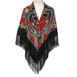 Detailed view of black floral fringe shawl, ethnic paisley pattern for autumn and winter style.