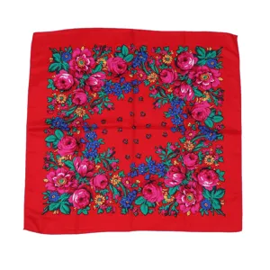 Detailopname van de levendige rode bloemige vierkante hoofddoek met rijke traditionele print.