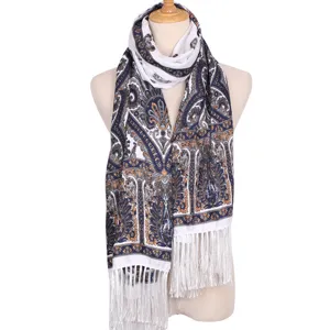 Detailed view of the bohemian paisley printed long scarf with delicate white fringe.