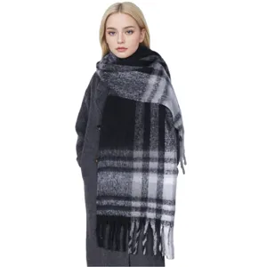 Winter thick warm black and grey plaid scarf shawl detail shot, soft cozy fabric texture close up.