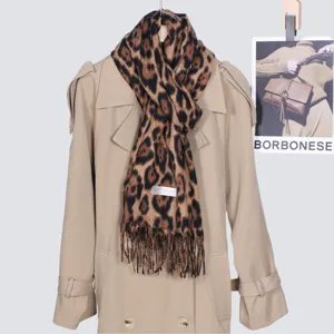 Leopard print scarf detail view, classic autumn and winter accessory draped on beige trench coat.