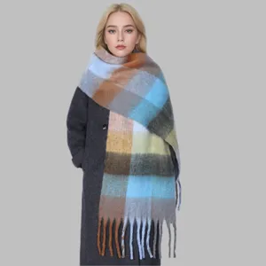 Close-up detail of the women colorful plaid tassel scarf worn by model in winter style.