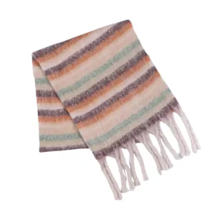 Women winter knitted striped scarf with fringe detail close-up view cozy warm neck wear