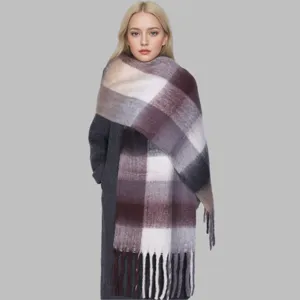 Detailed shot of women's thick mohair plaid scarf shawl with fringe, cozy winter accessory.