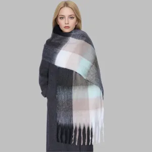 Detailed close-up look of the soft plaid winter scarf with fringe, cozy fashion accessory.