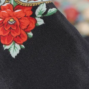 Close-up detail of traditional Russian floral print black fabric shawl scarf texture.