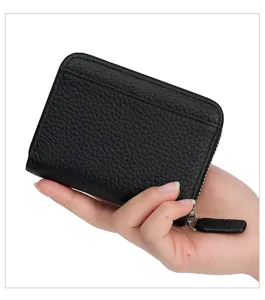 Close up detail of black genuine leather card wallet zipper coin purse with smooth texture.
