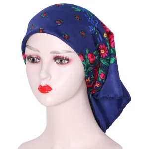 Detailed close-up of the blue floral print ethnic style headscarf worn on a mannequin.