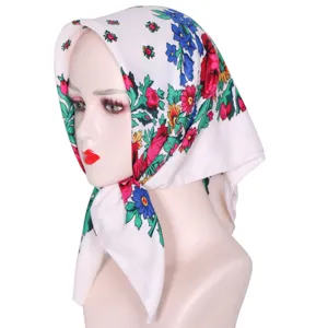 Close-up detail of Russian ethnic floral square headscarf showing vibrant traditional patterns.