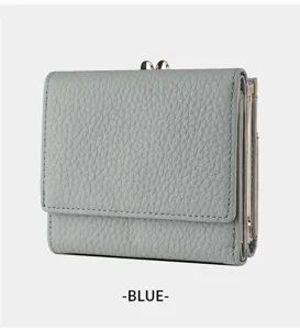 Detailed view of grey blue leather trifold women wallet with kiss lock clasp and card slots.
