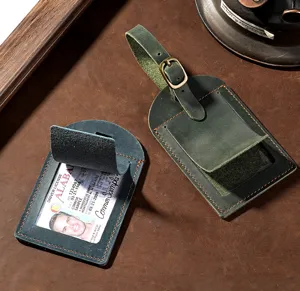 Vintage crazy horse leather luggage tag with buckle strap and clear ID slot for travel.