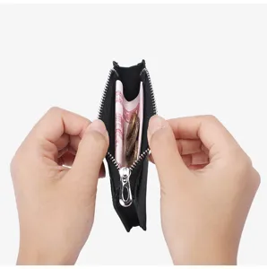 Detail view of slim leather coin purse and card holder interior capacity and zipper pocket.