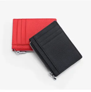 Close-up detail of slim leather card holder with multiple slots and secure zipper pocket.