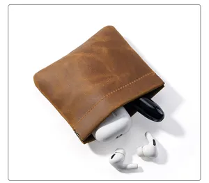 Genuine leather squeeze coin pouch, mini vintage earphone storage bag detail shot.