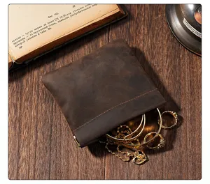 Vintage crazy horse leather coin purse with metal spring closure, elegant detail view display.
