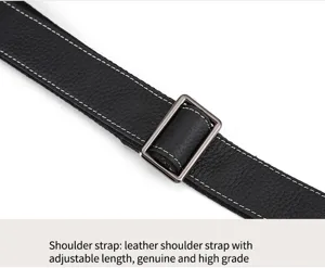 Adjustable genuine leather shoulder strap detail with metal buckle and neat white stitching.