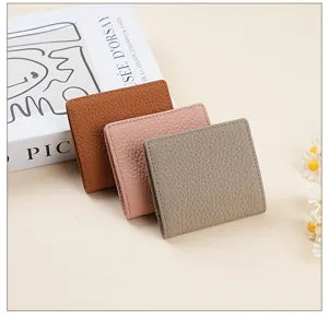 Bifold genuine leather coin purse mini wallet detail view showing soft texture and compact size
