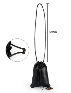 Detail view of black genuine leather drawstring lucky bag pouch showing 59cm strap and knot.