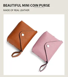 Detail view of mini leather coin purse with snap closure and handy pull strap in two colors.