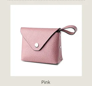 Close-up of pink mini leather coin purse detail, elegant snap closure and wrist strap design.