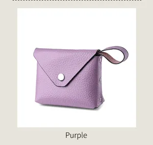 Purple leather mini coin purse detail view showing metal snap closure and wrist strap design.