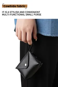 Mini genuine leather coin purse with snap closure and strap, stylish and portable daily pouch.