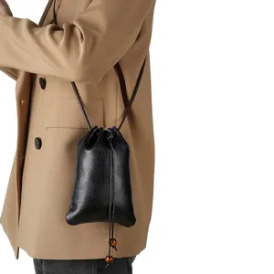 Genuine leather mini drawstring crossbody bag for women, stylish phone pouch and coin purse.