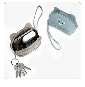 Close-up detail of genuine leather cat coin purse interior compartments and key ring setup.