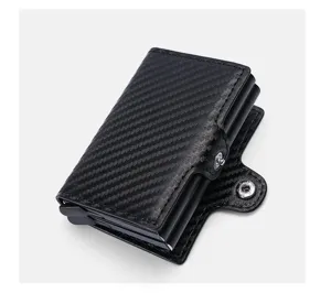 Detail view of the sleek carbon fiber minimalist wallet featuring an automatic pop-up card holder.