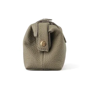 Genuine leather cosmetic pouch side view, taupe pebbled makeup bag for women and travel.