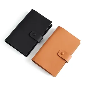 Agenda cuaderno profesional de cuero con cierre de botón a presión en negro y marrón.