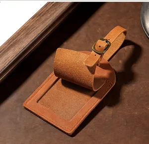 Detailed view of vintage crazy horse leather luggage tag, showing texture, buckle and card slot.