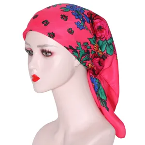 Detailed view of the pink Russian ethnic floral headscarf, vibrant roses pattern close up