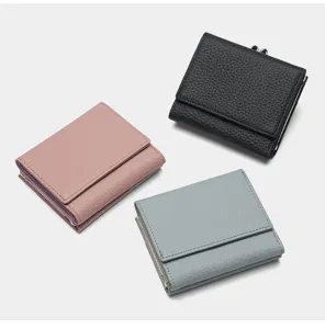 Detailed view of women's trifold leather coin purse featuring multi-card slots and kiss lock.