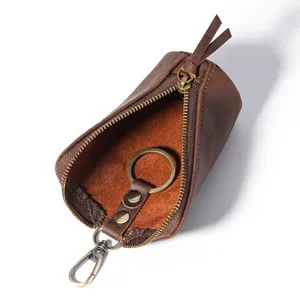 Étui à clés en cuir véritable pour homme avec fermeture éclair et anneau métallique.