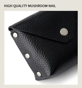 Black genuine leather mini coin purse with snap button closure and metal mushroom rivets.