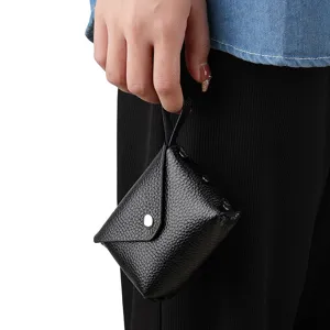 Mini black leather coin purse for women, compact snap closure wallet with strap daily use.