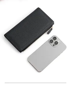 Detail view of a black pebbled leather long wallet with zipper, shown with a smartphone for scale.