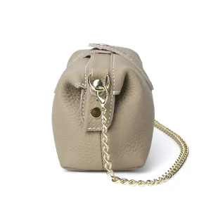 Stylish leather shoulder cosmetic bag with gold chain strap, compact and chic design.