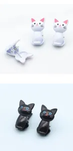 Detailed view of cute cat shaped plastic clips in black and white colors, ideal for sealing.